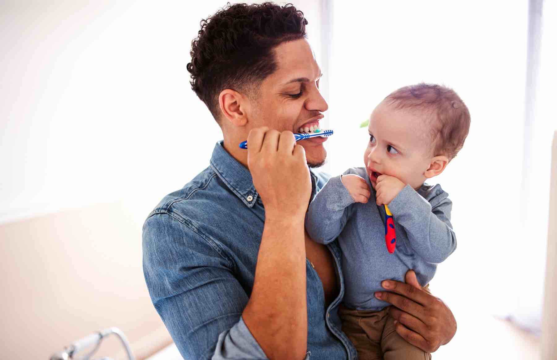 Preventive Dentistry | King Dental in Chicago |  African American father and son brushing teeth together